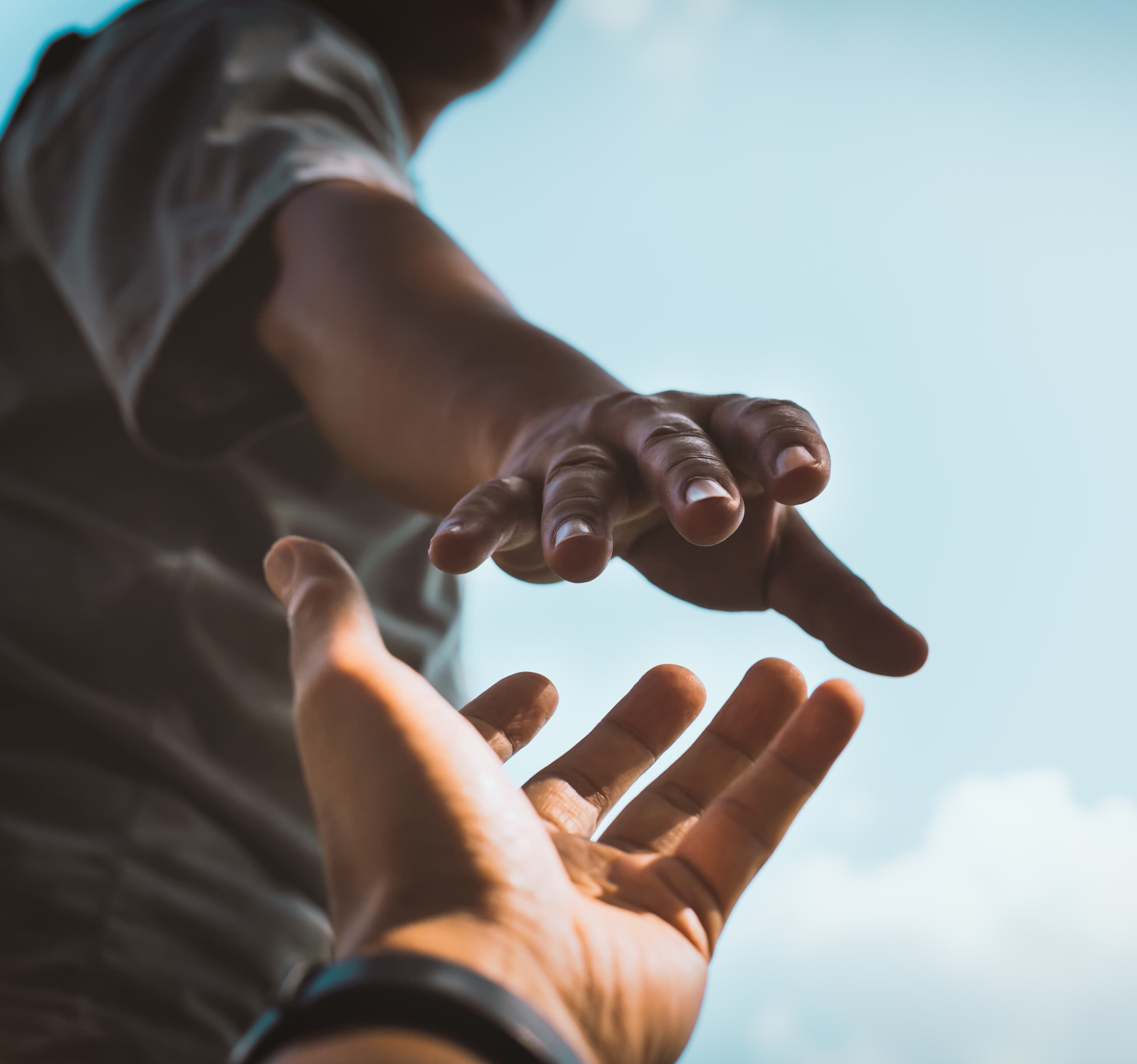 Two people hold hands